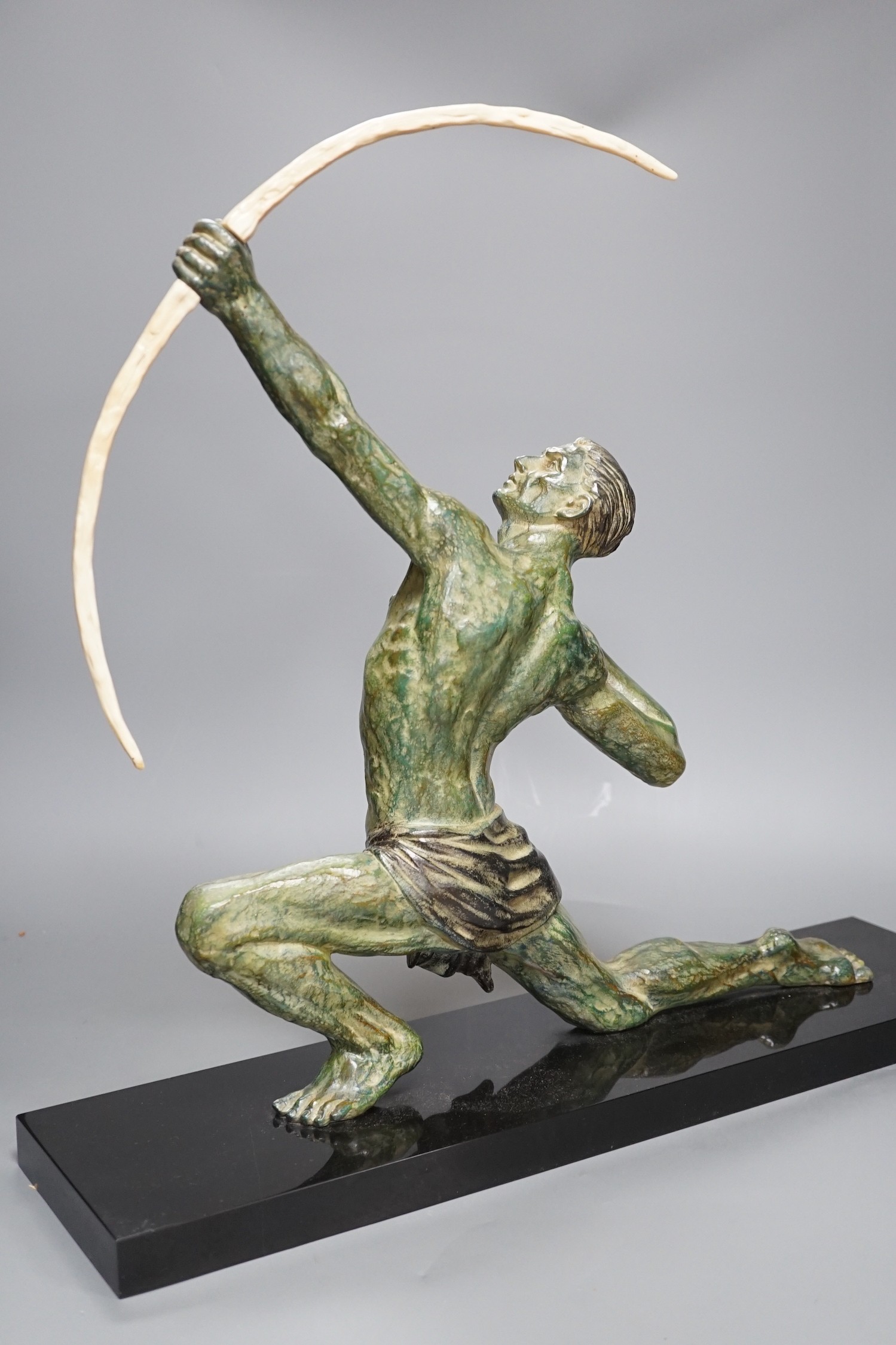 A large Art Deco bronzed figure of an archer, on black marble stand, 55 cms wide